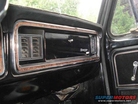 Dashboard with wood trim, air vents, and a 'Ranger' badge on the glove compartment