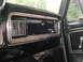 1979 Ford Bronco - Close-up of a vintage vehicle's dashboard, showing wood grain accents and the 'Ranger' emblem.