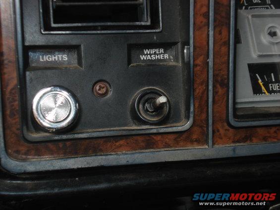 Interior dashboard with wood grain trim, lights, and wiper washer buttons
