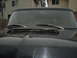 1979 Ford Bronco - Front view of a black vehicle's hood and windshield, a hood scoop.