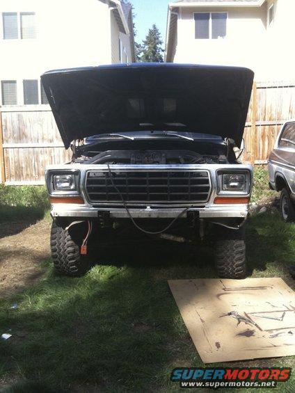 1978 Ford Bronco front view, hood open, parked in a yard next to another vehicle