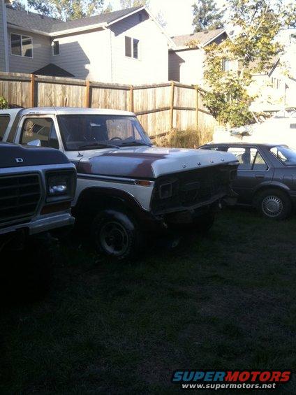 1979 Ford Bronco, front end missing, parked in grass