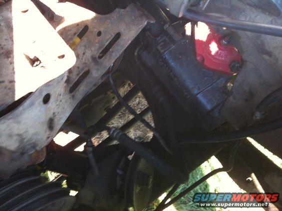 close-up of a vehicle's power steering pump and surrounding frame components