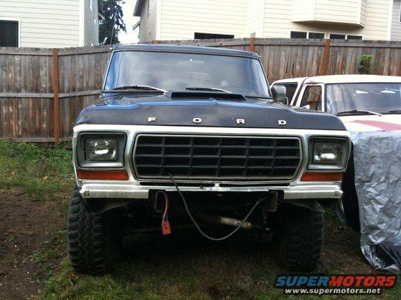 Black 1979 Ford Bronco front view, lifted with large tires, grille visible