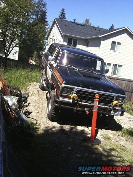 1979 Ford Bronco on a dirt incline with a house in the background. License plate reads 91-VBD