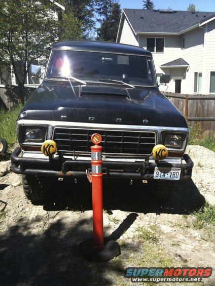 Black 1978 Ford Bronco front view with KC lights and a license plate reading 914-VBD