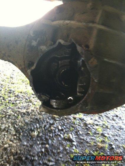 close-up of a damaged differential housing with gears visible inside
