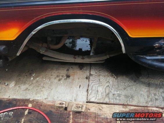 1979 Ford Bronco rear wheel well with chrome trim and leaf spring suspension