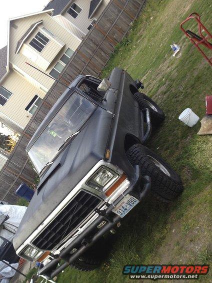 1979 Ford Bronco 3q-front view, black with off-road tires and custom bumper