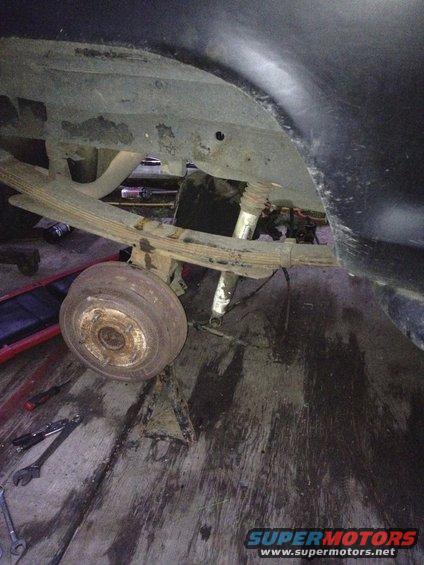 Rear leaf spring suspension and drum brake assembly on a vehicle undergoing repair