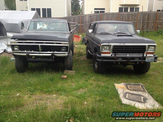 1979 Ford Bronco and a Ford F-Series truck parked in a grassy yard