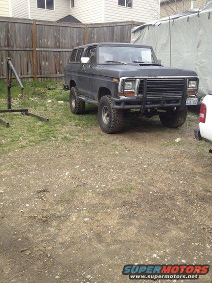 1979 Ford Bronco with off-road tires parked in a yard