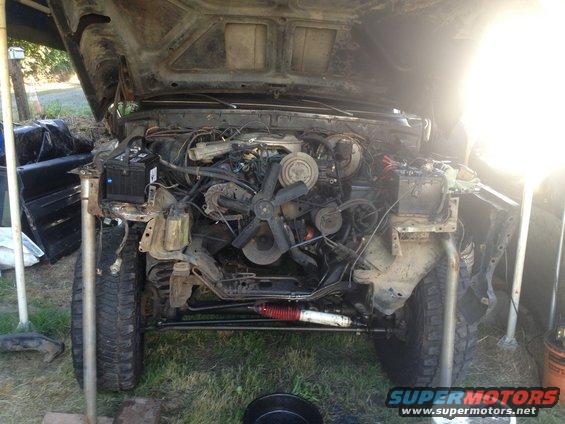 1978 Ford Bronco engine bay with hood open, showing disassembled engine and front end
