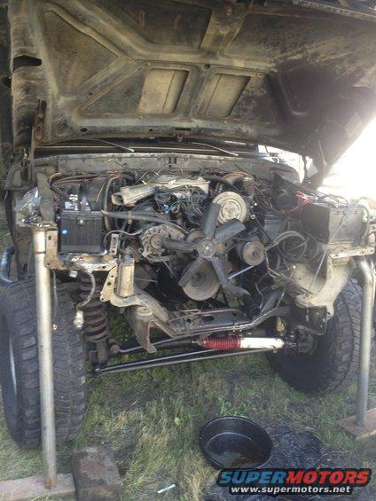 1979 Ford Bronco engine bay with hood open, front end disassembled