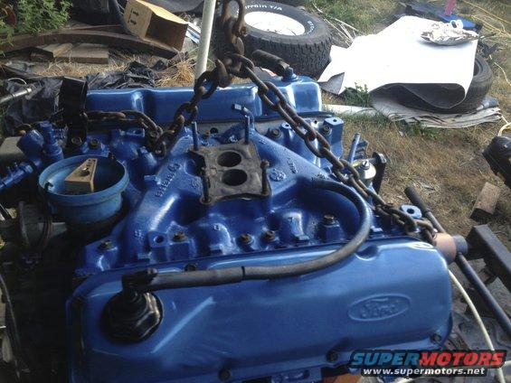 Blue Ford engine with chains, carburetor visible