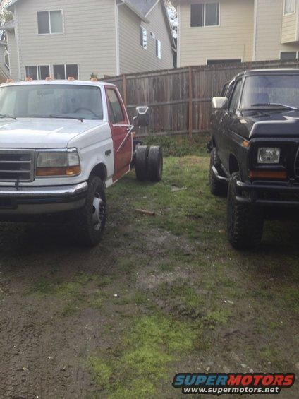 1979 Ford Bronco and a newer model truck chassis parked side-by-side