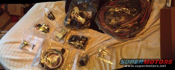 Wiring harnesses and electrical components laid out on a textured surface