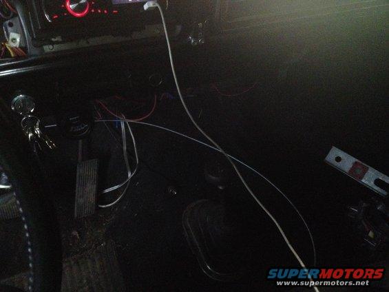 Close-up of a dark vehicle interior, possibly a dashboard or seat