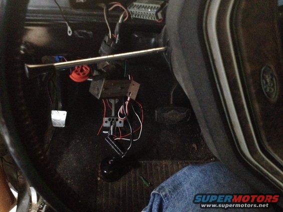 1979 Ford Bronco interior showing steering column, pedals, and exposed wiring near the floor