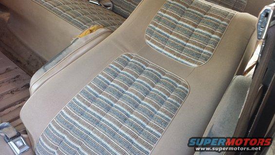 Tan interior seats with striped fabric inserts. 1984 Ford Bronco