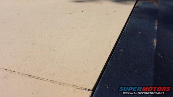 Tan and dark blue car hood seam