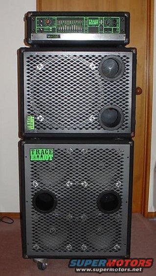 Trace Elliot bass amp head on top of two speaker cabinets. The cabinets have metal grilles and visible speakers