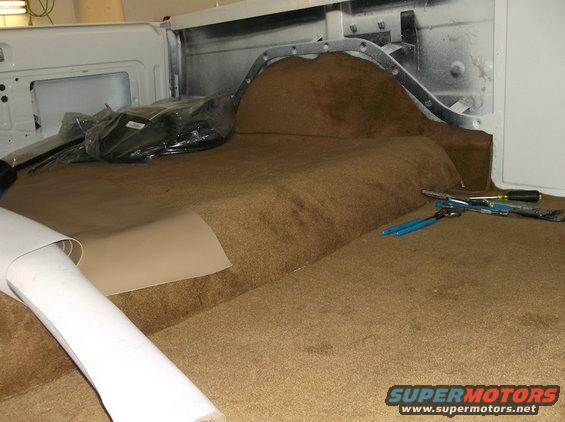 Interior of 1979 Ford Bronco with new carpet being installed
