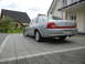 1999 Ford Fairlane - This silver sedan is parked on a paved driveway in front of a residential house.