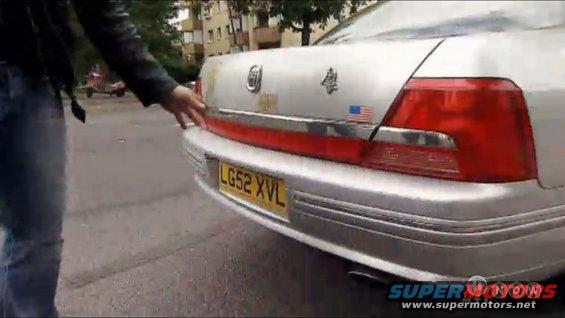 Silver sedan rear with red taillights and yellow license plate LG52 XVL