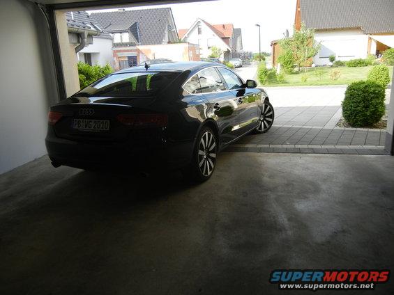 Black Audi with license plate PB WG 2010 parked in a garage