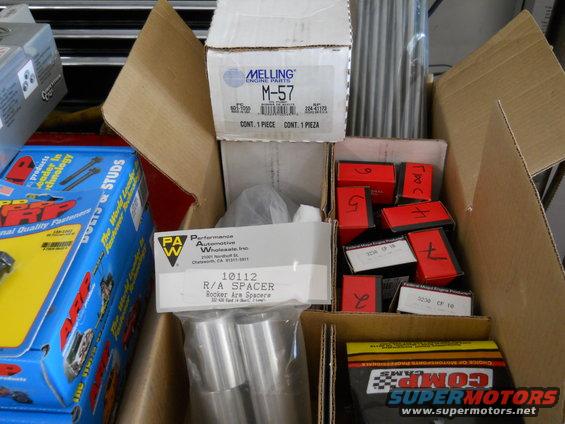 Boxes of Melling engine parts, rocker arm spacers, and ARP studs