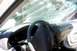 2000 Ford Taurus - Interior of a 2000 Ford Taurus showing a severely cracked windshield and worn dashboard.