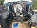 1986 Ford Bronco - The engine bay of a vehicle is exposed, revealing the engine, complex wiring, and front suspension components during a repair or restoratio…