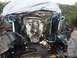 1986 Ford Bronco - Engine bay components and wiring are visible, with a tarp covering most of the vehicle.