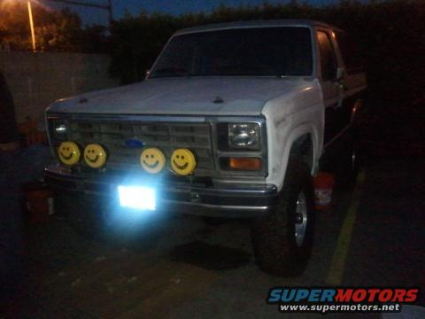 1986 Ford Bronco front view with four yellow smiley face lights on the grille