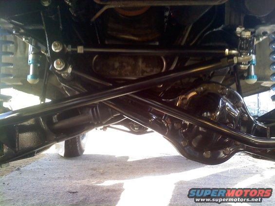 Underside of a vehicle showing suspension and differential components