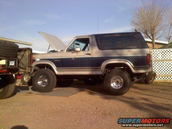 1986 Ford Bronco, two-tone blue and silver, hood open, parked outdoors
