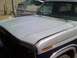1986 Ford Bronco - Close-up of a truck's hood and fender, showing a two-tone paint scheme and a watermark.