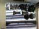 1986 Ford Bronco - A collection of freshly painted suspension parts, including brackets and what appear to be shock absorbers, are neatly arranged on a blanke…