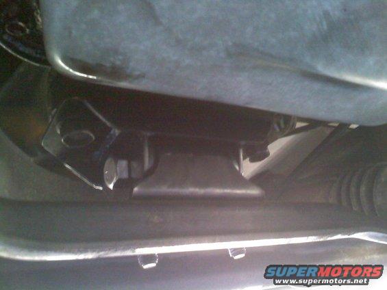 Undercarriage of a vehicle with visible bolts and metal brackets