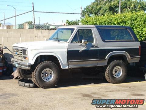 Two-tone gray and white Ford Bronco with aftermarket wheels parked outdoors