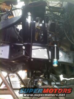 Black painted vehicle chassis with suspension components and a shock absorber