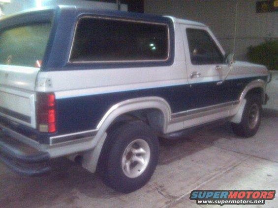 1986 Ford Bronco rear three-quarter view, blue and white two-tone paint