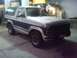 1986 Ford Bronco - Two-tone 1986 Ford Bronco with blue and white paint, seen at a gas station.