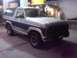1986 Ford Bronco - This two-tone Ford Bronco is parked at a gas station under the lights.