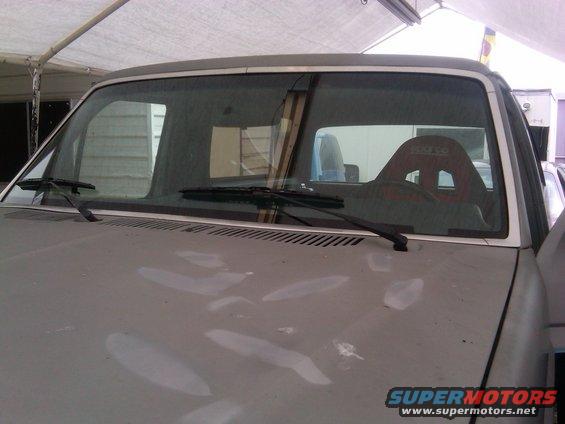 Interior view of a truck with a red racing seat visible through the windshield