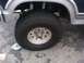 1986 Ford Bronco - Close-up of a vehicle's wheel and fender assembly, showing tire and rim details.