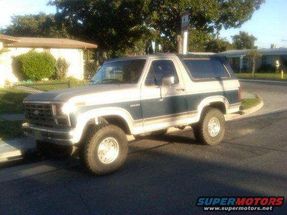 1986 Ford Bronco, two-tone paint, parked curbside