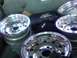 1986 Ford Bronco - Four shiny chrome wheels are visible in the back of a vehicle, possibly for transport or storage.