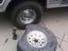 1986 Ford Bronco - Changing a flat tire requires tools like a lug wrench, screwdriver, and drill.